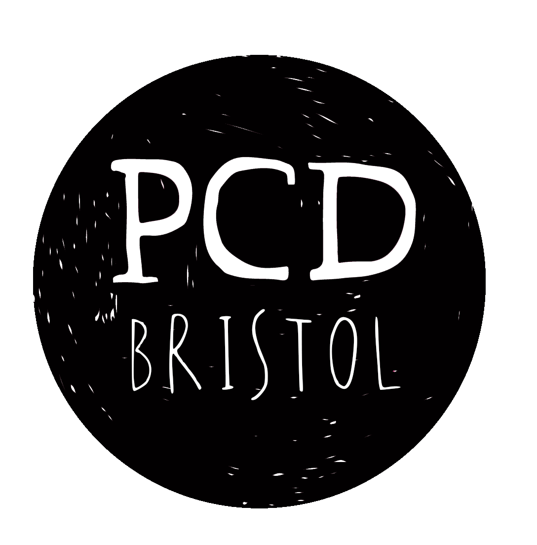 the PCD logo - a black inky circle with letters P C D in white